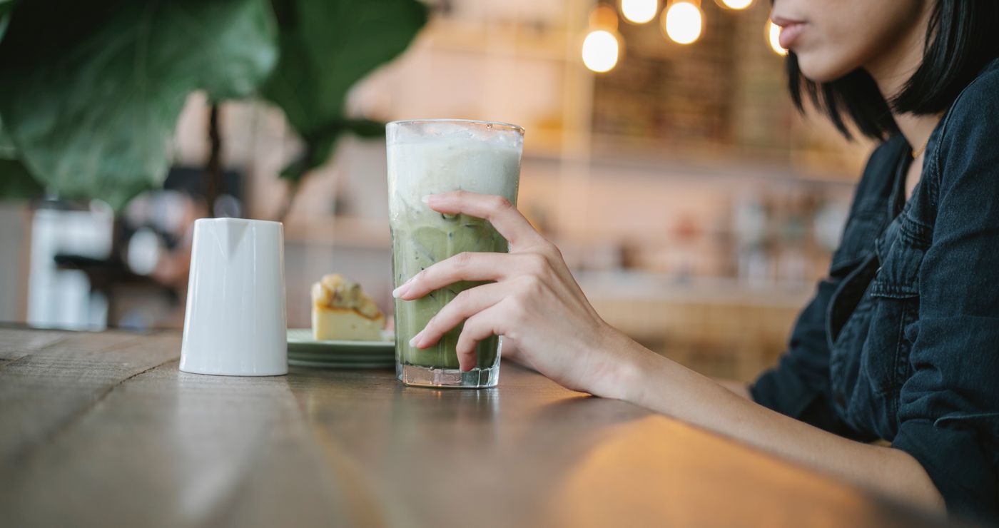 Guest with a matcha drink at a community social